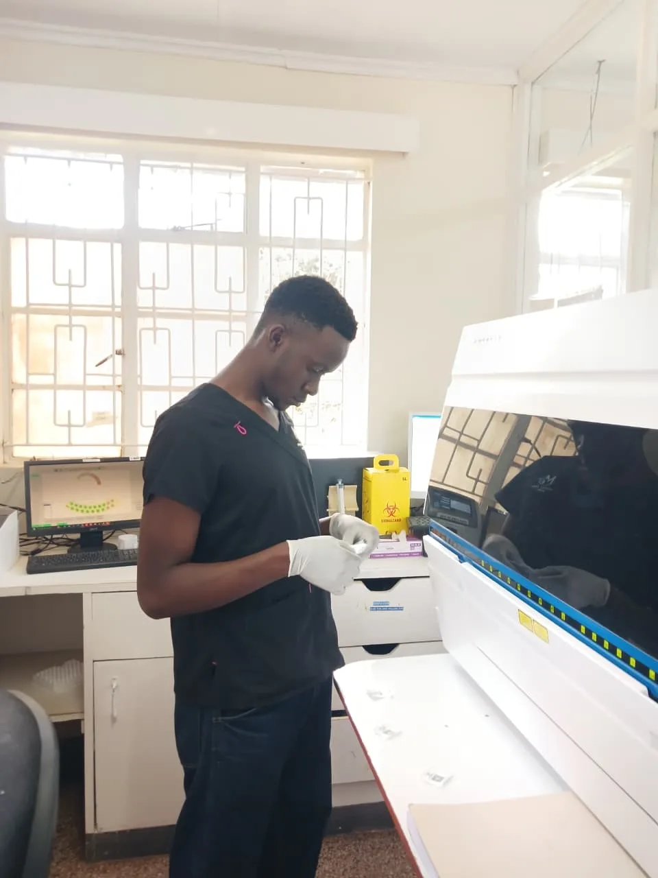 MEDevice Africa biomedical engineer preparing a sample in a hospital laboratory